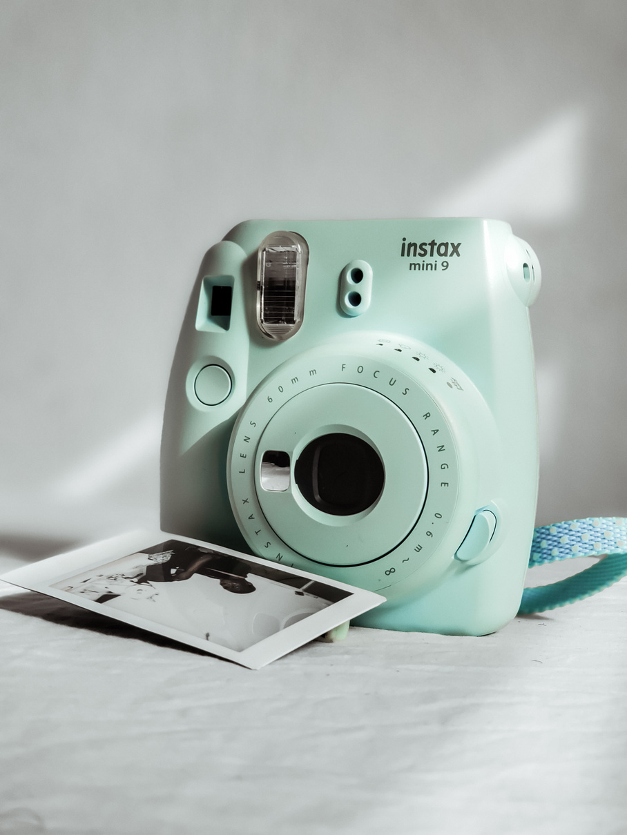 Teal and White Camera on White Table